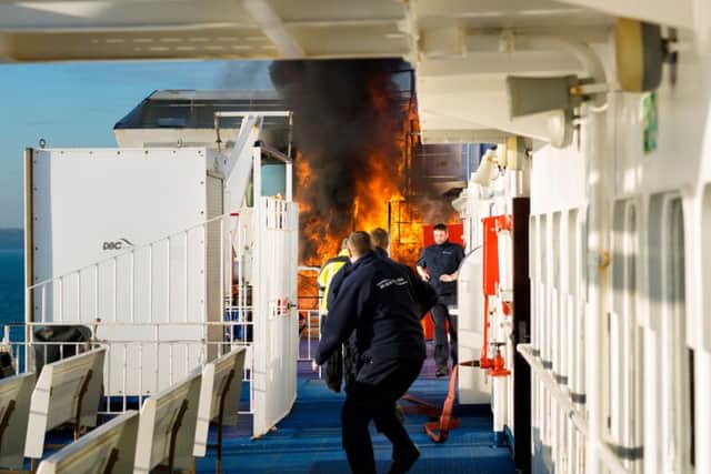 Crew of the Wightlink ferry, St Faith, rush to extinguish a fire as it takes hold close to the bridge of the vessel as it sails to Fishbourne on the Isle of Wight..
Picture by Christopher Ison.