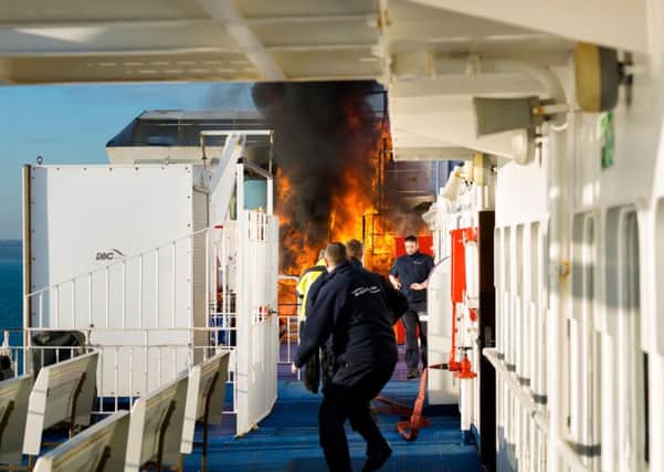 Crew of the Wightlink ferry, St Faith, rush to extinguish a fire as it takes hold close to the bridge of the vessel as it sails to Fishbourne on the Isle of Wight..
Picture by Christopher Ison.