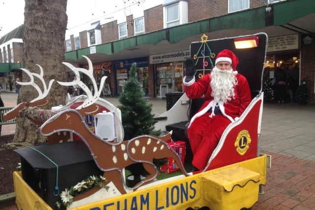 Shoppers dug deep to fill Father Christmas collection buckets for Fareham Lions Club
