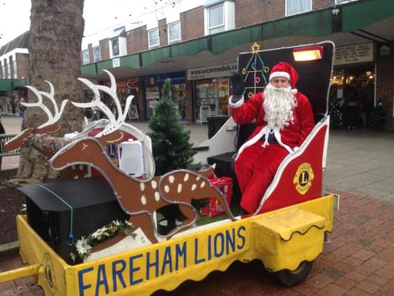 Shoppers dug deep to fill Father Christmas collection buckets for Fareham Lions Club