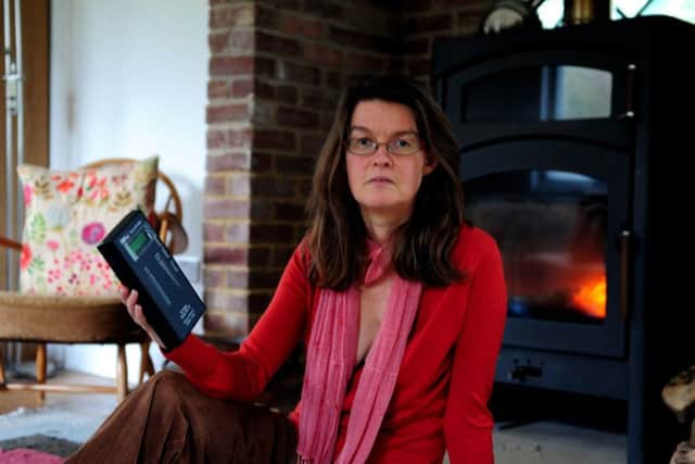 Rachel Hinks, with a device that measures electromagnetic energy to which she is allergic. 170010-3 SUS-170116-192536008