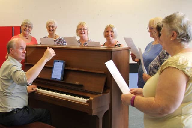 Patrick Nicholls, the leader of Resonate choir, with members who just love to sing