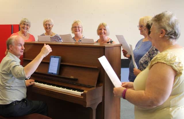 Patrick Nicholls, the leader of Resonate choir, with members who just love to sing