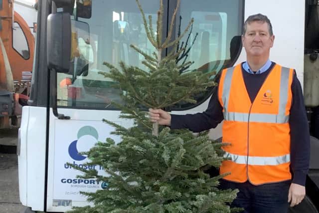 Nigel Walters, from Urbaser, the councils refuse and recycling collection 
contractor, with one of the Christmas trees collected for recycling in Gosport.