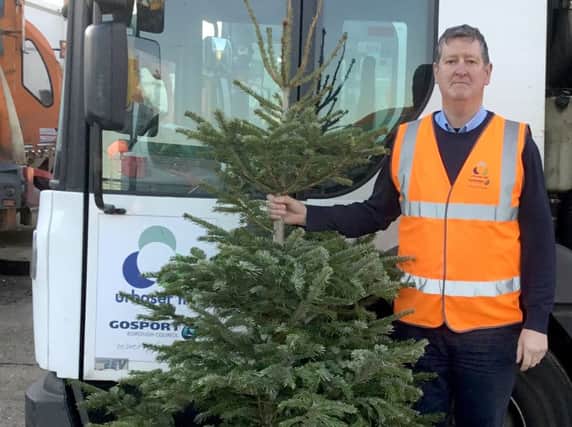 Nigel Walters, from Urbaser, the councils refuse and recycling collection 
contractor, with one of the Christmas trees collected for recycling in Gosport.