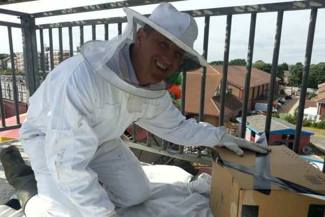 Mark Powell collects the bees from the Runaway Mine ride at Funland, Hayling Island