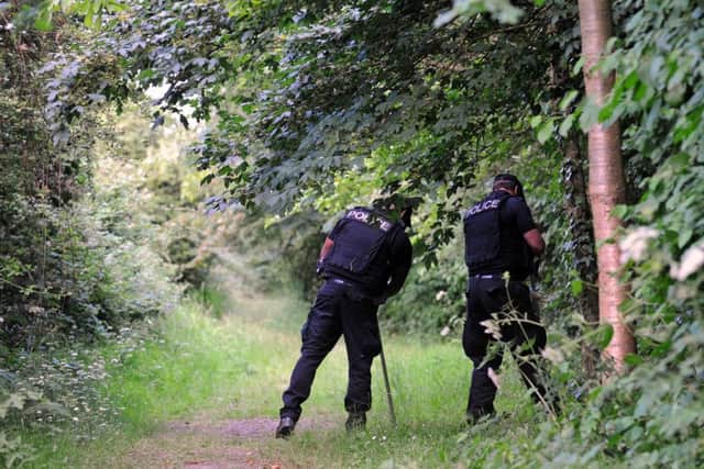 Police searching woods at Hilsea Lines, Portsmouth where a woman was stabbed by Ben Moynihan