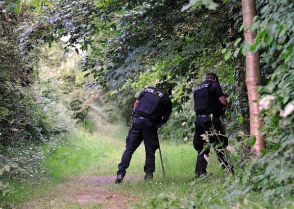 Police searching woods at Hilsea Lines, Portsmouth where a woman was stabbed by Ben Moynihan