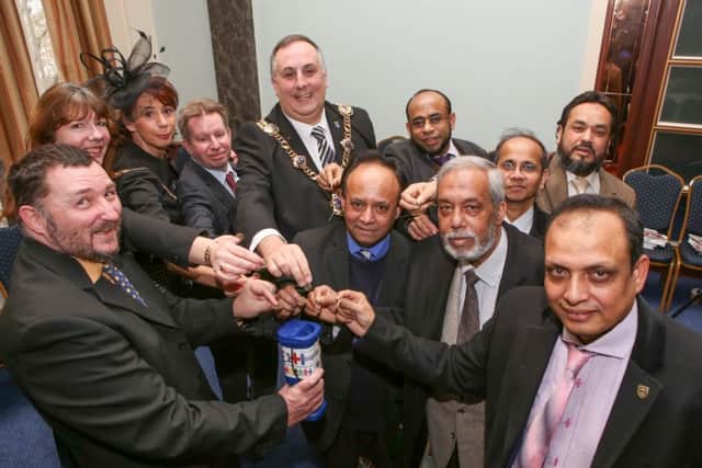 Lord Mayor of Portsmouth David Fuller and members of the Â£1 Hospital Charity placing a pound into the charity collection Picture: Habibur Rahman (170117-669)