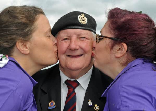 A free day of entertainment was held at Portsmouth Historic Dockyard for Armed Forces Day last year. Veteran Paul Hyde gets a smacker from Anna Mould, left, and Vie Portland from the Strolling Sirens 
Picture: Ian Hargreaves (160844-3)
