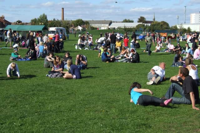 People enjoying the sun in Leesland Park