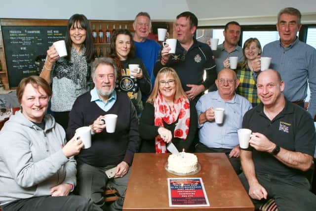 Tracy Watson cutting the cake with Army, RAF and Royal Navy veterans  Picture: Habibur Rahman