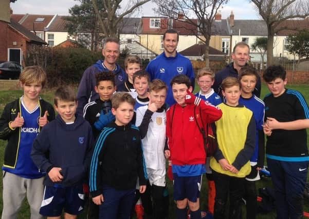 Pompey defender Christian Burgess, back row centre, attended Skilful Soccer Youth under-12s training session on Saturday after the Blues game at Crawley was called off because of a frozen pitch