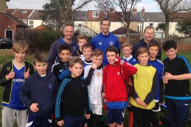 Pompey defender Christian Burgess, back row centre, attended Skilful Soccer Youth under-12s training session on Saturday after the Blues game at Crawley was called off because of a frozen pitch