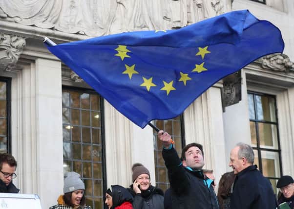 A man waves a flag outside the Supreme Court in London where Britain's most senior judges will rule if Theresa May has the power to trigger the formal process for the UK's exit from the European Union. PRESS ASSOCIATION Photo. Picture date: Tuesday January 24, 2017. Ministers are braced for the Supreme Court to decide that Parliament must be given a vote on starting the divorce proceedings. See PA story POLITICS Brexit. Photo credit should read: Jonathan Brady/PA Wire PPP-170124-104207001