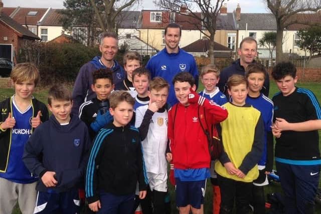 Pompey defender Christian Burgess, back row, centre, attended Skilful Soccer Youth under-12s training session on Saturday