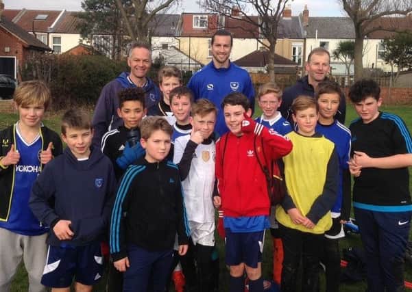 Pompey defender Christian Burgess, back row, centre, attended Skilful Soccer Youth under-12s training session on Saturday