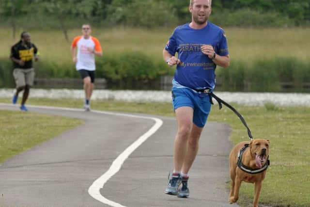 Ainsley Rood running at Lakeside with his dog Enzo. Picture: Mick Young