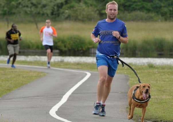 Ainsley Rood running at Lakeside with his dog Enzo. Picture: Mick Young