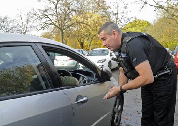 File photo of roads policing officer PC Mark Fruin talking to a man caught using his phone