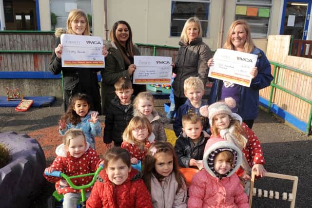 The YMCA Gosport Nursery has been given Â£657 by parent Angie Tailor-Joice raised after the nursery was vandalised. Back from left, lead practitioner Chelsea Howard,parent Angie Tailor-Joice, nursery manager Jo Currass, and pre-school room leader Lisa Thomas 

Picture: Sarah Standing (170075-1273)