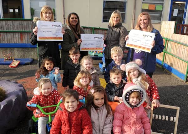 The YMCA Gosport Nursery has been given Â£657 by parent Angie Tailor-Joice raised after the nursery was vandalised. Back from left, lead practitioner Chelsea Howard,parent Angie Tailor-Joice, nursery manager Jo Currass, and pre-school room leader Lisa Thomas 

Picture: Sarah Standing (170075-1273)