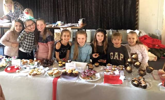 Lucy Fairall and friends at the bake-off competition for Cancer Research. Left, some tasty cakes