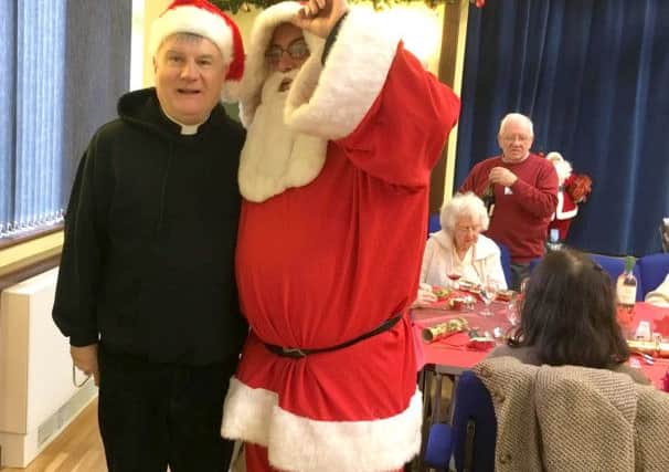 Rev Ian Meredith and Cllr Geoff Fazackarley dressed as Santa at St Marys Christmas Day lunch