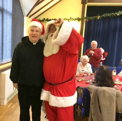 Rev Ian Meredith and Cllr Geoff Fazackarley dressed as Santa at St Marys Christmas Day lunch