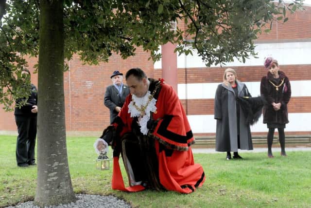 27/1/2017 (WR)
Holocaust Memorial Service Day took place on Friday 27th January at the D-Day Museum.
Pictured is: The Lord Mayor of Portsmouth David Fuller placing the lit candle at the base of the Holocaust Memorial Tree.
Picture: Sarah Standing (170133-1731) PPP-170127-154340001