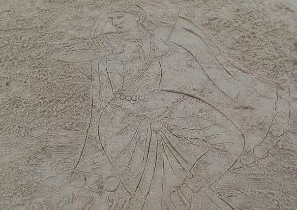 Sydney Kerens spotted a mystery artist drawing this image in the sand in Portsmouth