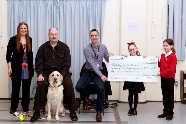 Portsdown Primary School raise record amount for Guide Dogs for the Blindcaption Left to right:Daphne Wright, Deputy head teacher, Ian Morris, Volunteer speaker for Guide dogs with Gunner,  Leigh Thresher, community fund raiser for Hampshire Guide dogs, Connie a year 3 pupil and Matilda a year 3 pupil.
Picture: Daphne Wright