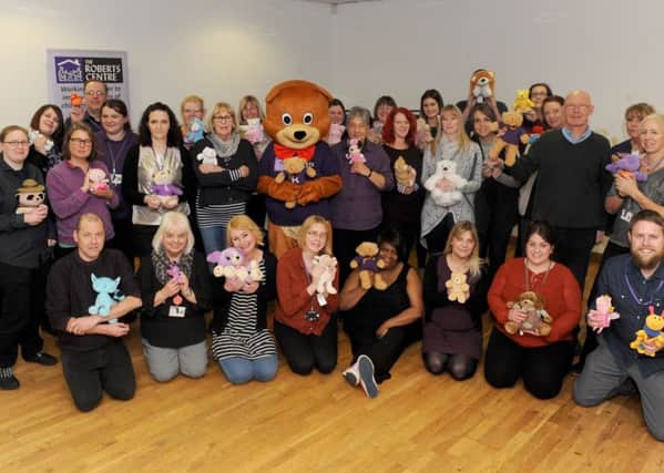 Staff from The Roberts Centre joined together at Landport Community Centre to mark the launch of the Find Robert The Bear Competition. Picture: Sarah Standing (170129-1543)