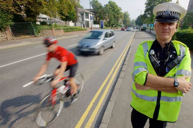 Officers carrying out a road safety operation tackling the issue of drivers not allowing cyclist enough clearance during overtaking. Picture: West Midlands Police