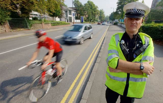 Officers carrying out a road safety operation tackling the issue of drivers not allowing cyclist enough clearance during overtaking. Picture: West Midlands Police