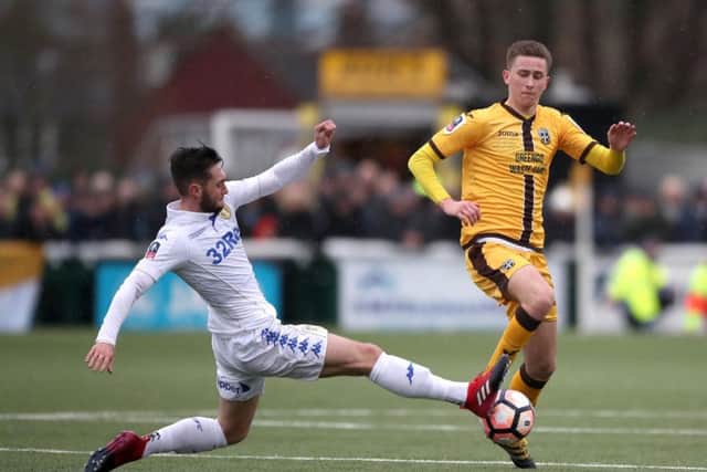 Adam May challenges Leeds United's Matt Grimes (left)