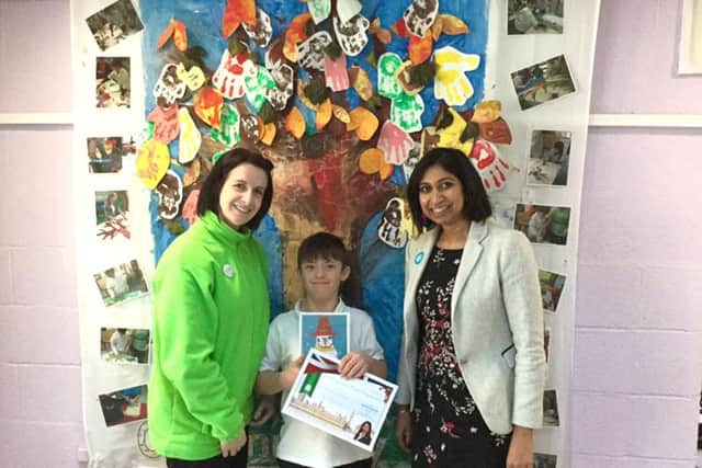 Ryan Couzens with a teacher, left, and Fareham MP Suella Fernandes