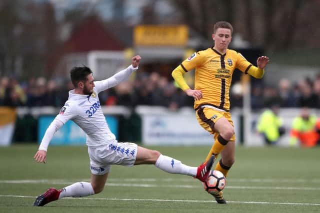 Adam May, right, is challenged by Leeds Matt Grimes during Sundays FA Cup game at Gander Green Lane