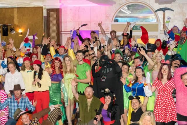 Taylor Made Computer Solutions staff in Disney-themed costumes as part of the companys annual post-Christmas party