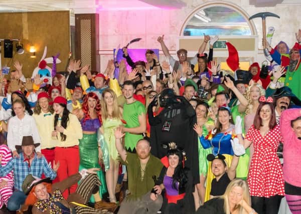 Taylor Made Computer Solutions staff in Disney-themed costumes as part of the companys annual post-Christmas party