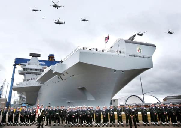 HMS Queen Elizabeth at her current base in Rosyth, Scotland, during a fly-by    PHOTO:  Andrew Milligan/PA Wire