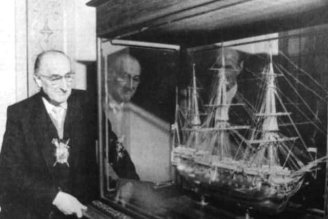 The Lord Mayor admires a superbly crafted model of HMS Victory in his parlour