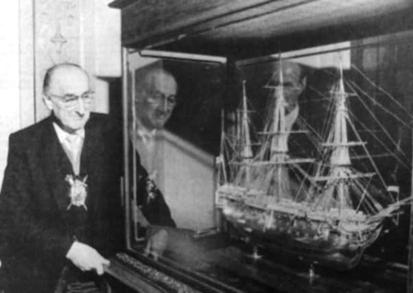 The Lord Mayor admires a superbly crafted model of HMS Victory in his parlour