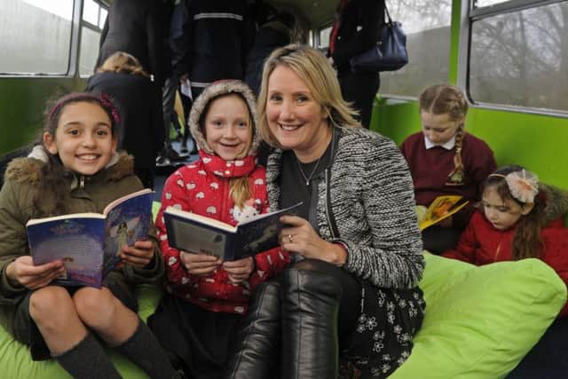 (Left to right)  Layla Wright and Grace Robinson, both eight, with Caroline Dinenage and enjoying a good read along with Amber Robinson (10) and Daisy Scott (nine)