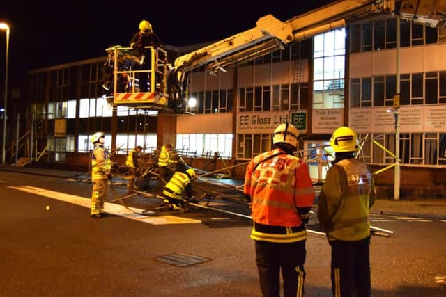 Firefighters lowered the wrecked metal work carefully to the floor using an aerial ladder platform and rope