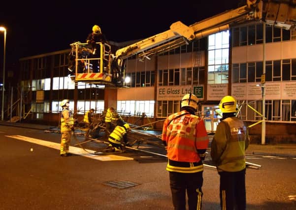 Firefighters lowered the wrecked metal work carefully to the floor using an aerial ladder platform and rope