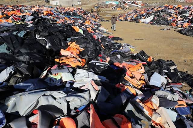 British expatriate Eric Kempson, who is battling to save lives on the Greek island of Lesbos, stands between mountains of used life jackets, which he said the majority of which are fake and include at least 150,000 vests, half of the original amount that began to accumulate after long trips to the main tip became unsustainable owing to the large influx of refugees and subsequent life jackets, located on the island close to his home in Eftalou, where the 61-year-old warned the refugee crisis is far from over. PRESS ASSOCIATION Photo. Picture date: Wednesday February 1, 2017. Mr Kempson, originally from Hampshire, said the boats are still coming, with refugees often wearing fake life jackets and during winter are at risk of hypothermia and frostbite. See PA story RESCUE Lesbos. Photo credit should read: Owen Humphreys/PA Wire RESCUE_Lesbos_070379.JPG