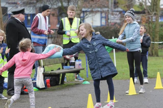 Roxy Skirrow and her sister Carmen giving participants a high five on Sunday. Picture: Habibur Rahman