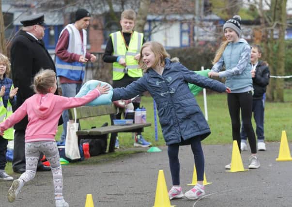 Roxy Skirrow and her sister Carmen giving participants a high five on Sunday. Picture: Habibur Rahman