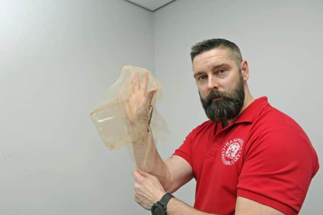 07/02/17 BF
Police staff member Lee Byrne works with News reporter Ben Fishwick as he tries on the new anti-spit hood which is being issued to Hampshire Police.
Picture Ian Hargreaves (170210-1) PPP-170702-174945006